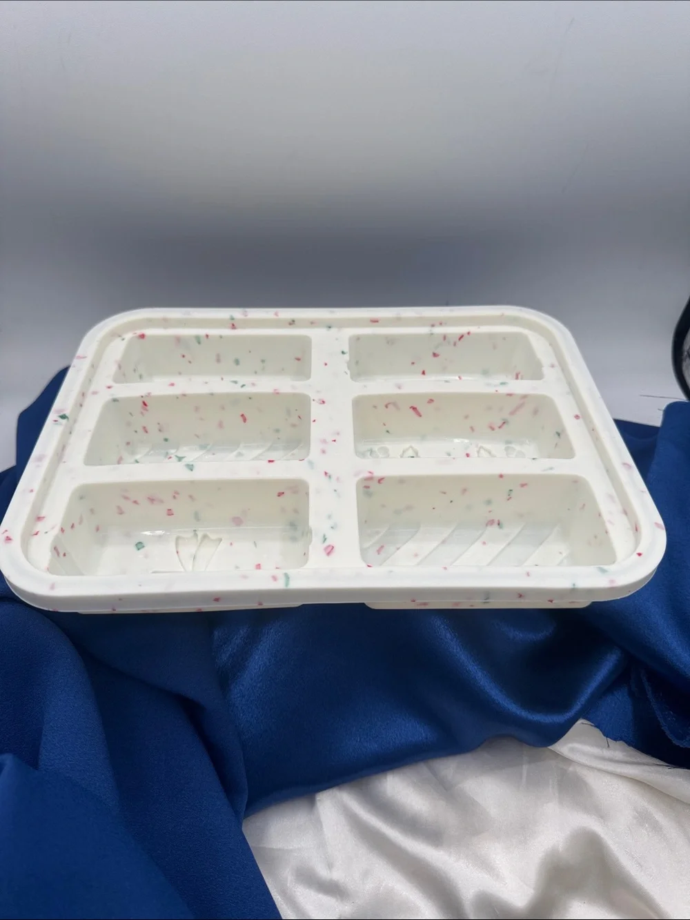 This image shows a holiday-themed silicone snap bar mold being used to create fe